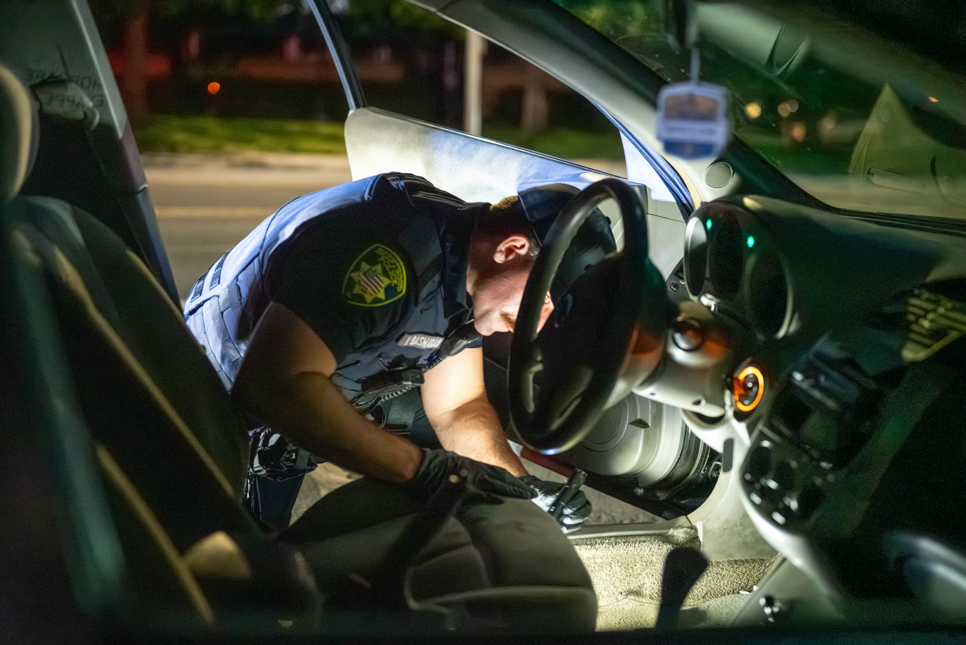 Officer searching a vehicle by flashlight